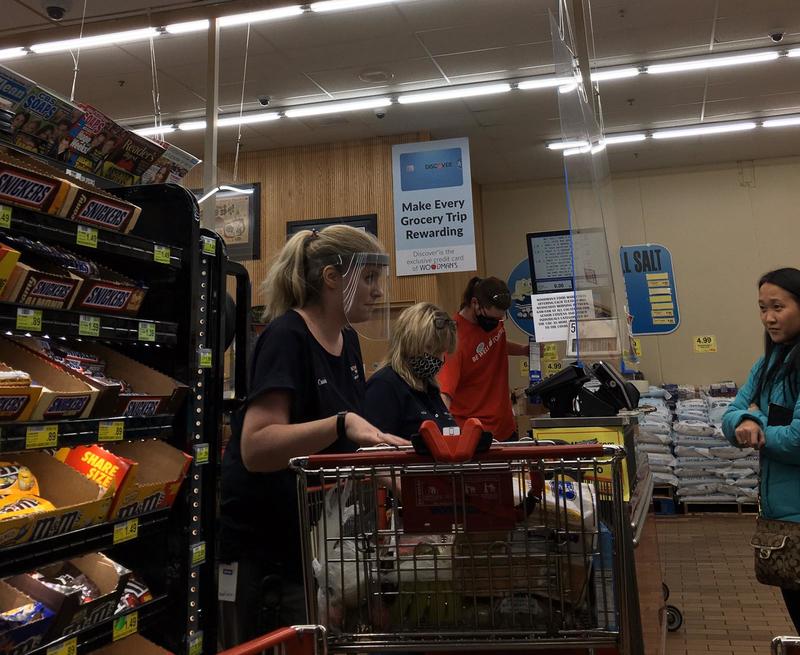 People in the checkout line at the supermarket. 