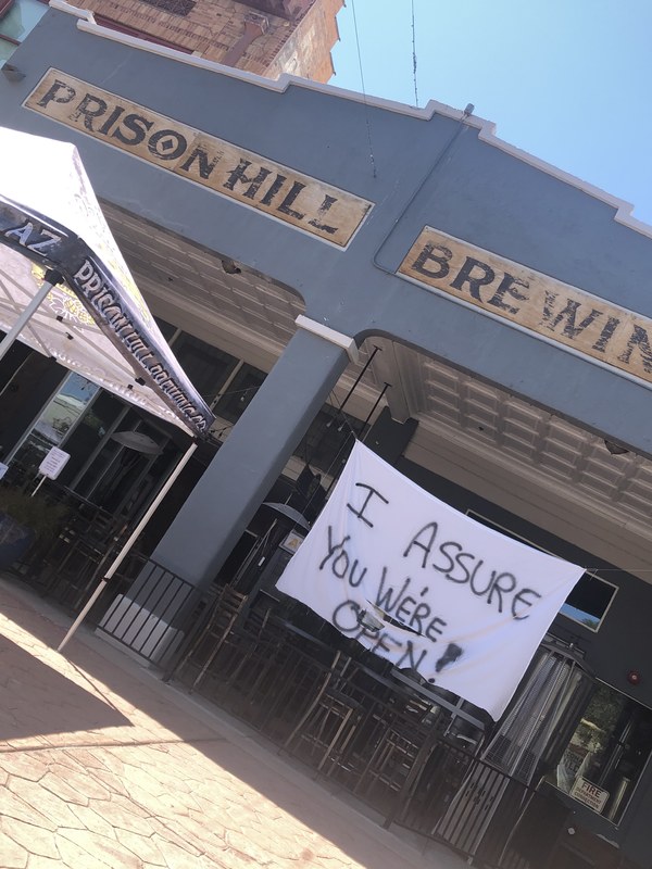 A white sign outside of a store.