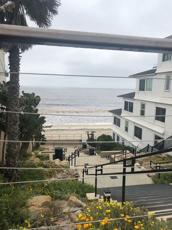 An empty stairway towards a beach.