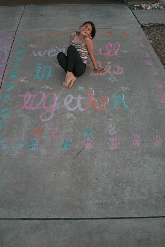 A person sitting in a chalk drawing. 