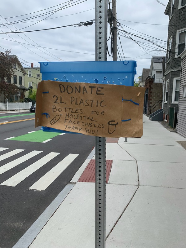 Sign asking for 2L water bottles to use for hospital face shields.