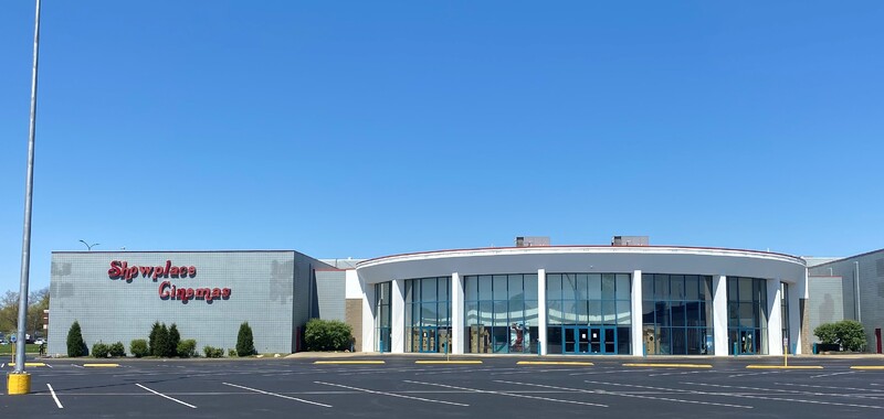 Photo of an empty parking lot outside a movie theater. 