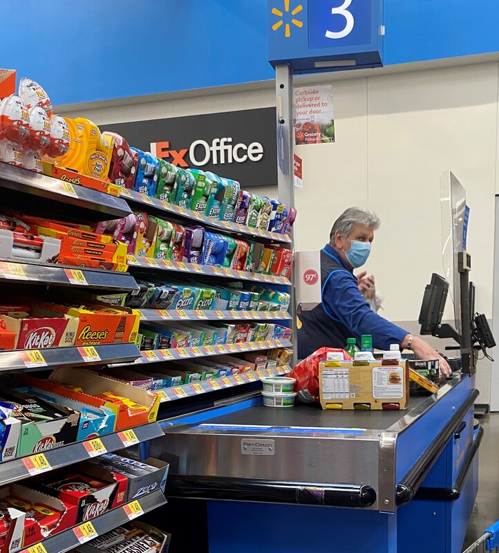 A masked cashier at a Walmart.