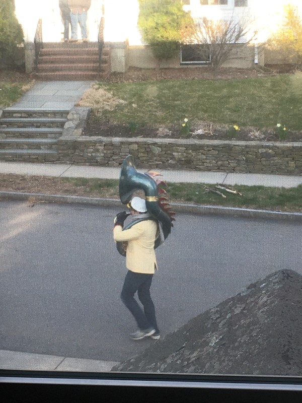 A man playing a sousaphone in the street.