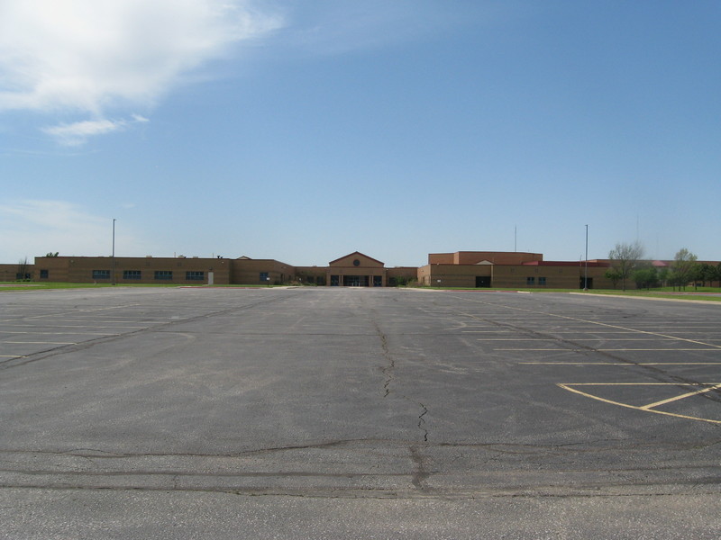 Image of an empty school parking lot.