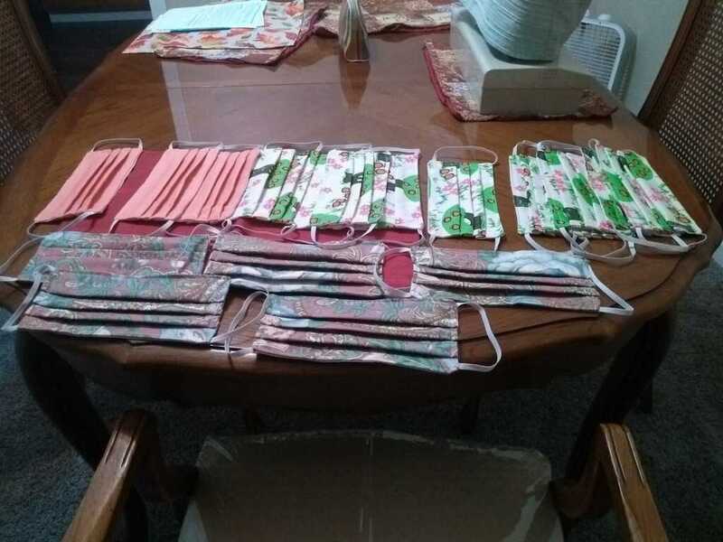 This is a picture of a collection of face masks that are spread out on a table. 