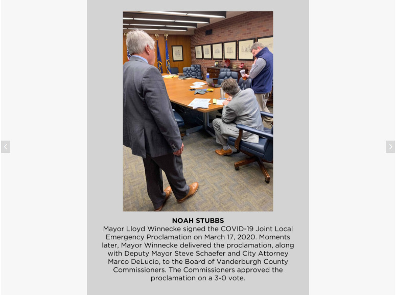 Photo of three men signing documents.