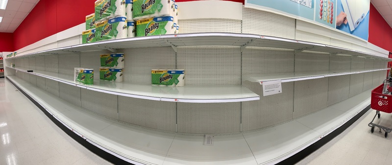 A row of shelves with paper towels stacked on top of them. 