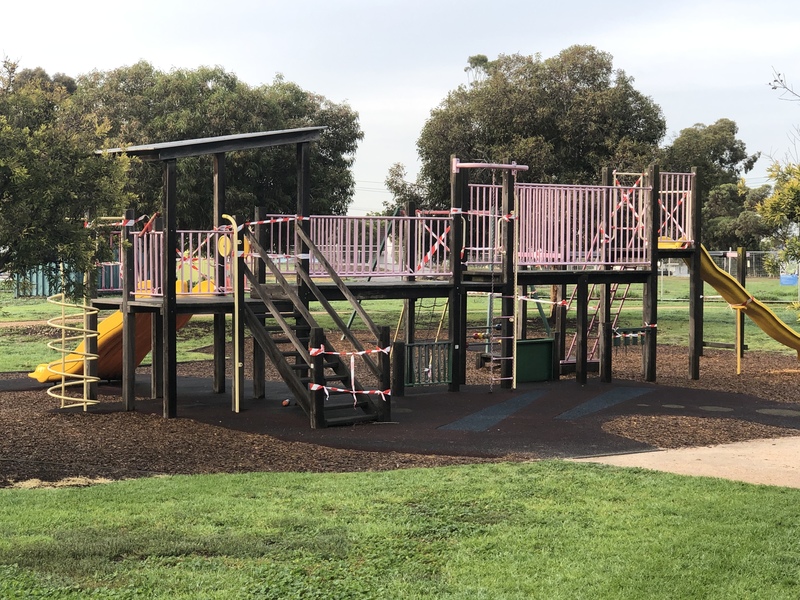 A playground that is sectioned of with tape to ensure no one plays on it.