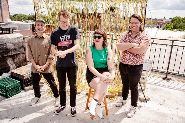 Four people smiling and laughing. 