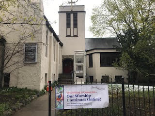 Church with a sign that reads "Our worship continues online".