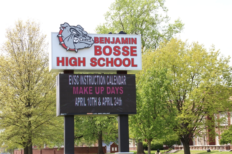 A school sign reading "EVSC Instruction Calendar Make Up Days April 10th and April 24th". 