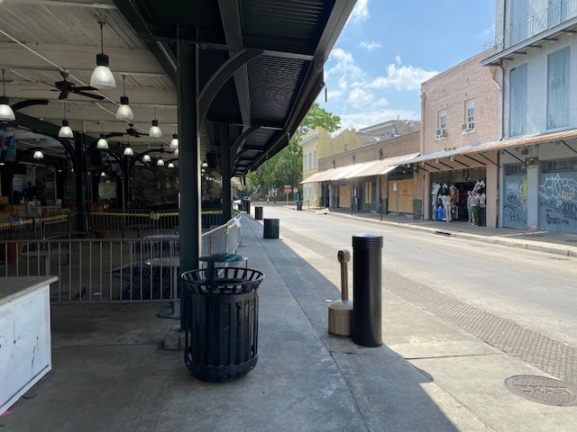 An empty street with numerous stores. 