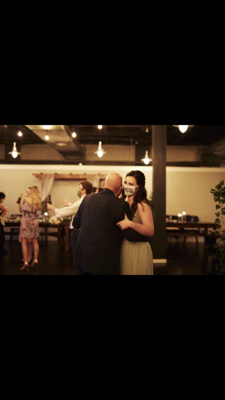 Masked man and woman in formal clothing, dancing. 