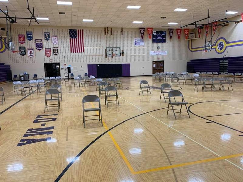 Image of chairs spread out in a school gym for graduation.