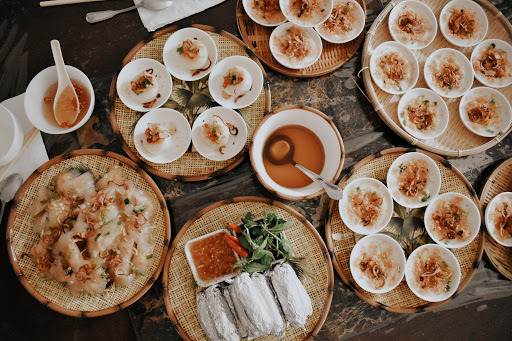 This is a picture of several platters of food set on a table, ready to eat. 