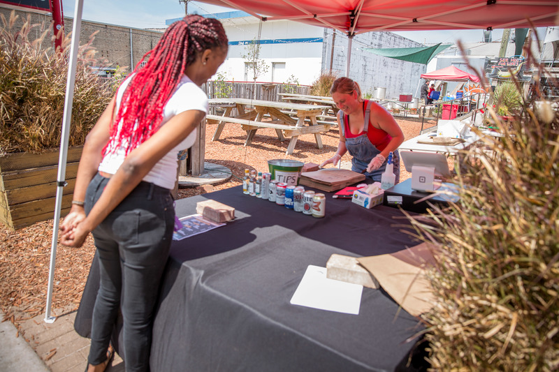 A costumer and employee at Clesi’s Seafood food tent.