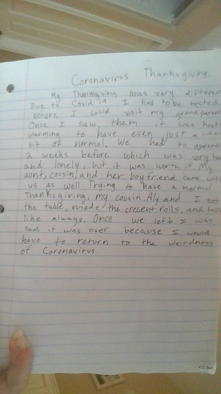 This is a picture taken of a paragraph written on notebook paper about a person's experience celebrating Thanksgiving during the COVID-19 pandemic. 