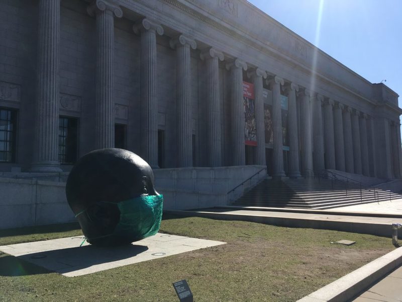 Sculpture "Day" has a mask on outside the Museum of Arts in Boston. 