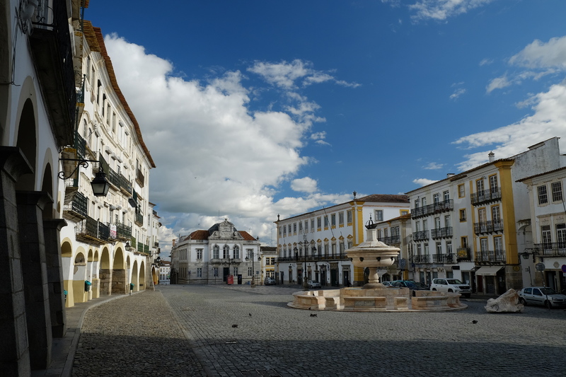 An empty square with an empty water fountain.