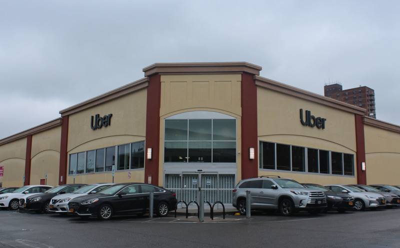 A closed building with cars surrounding it.