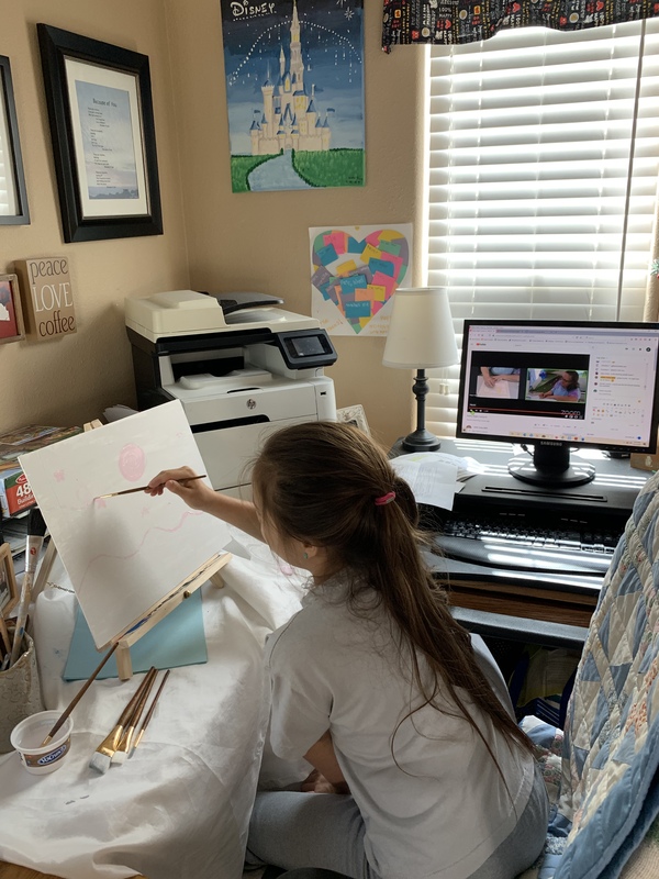 A photo of a child painting.