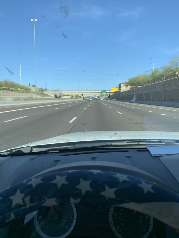 A person driving on an empty highway during rush hour. 