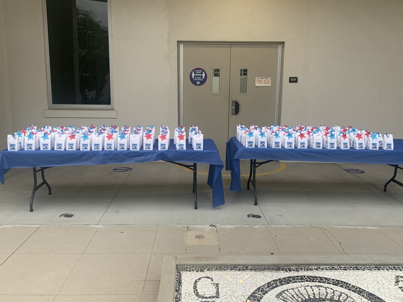 This is a picture taken of two collapsible tables that are covered in gift bags. 