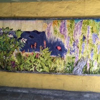 This is a picture of a mural painted which depicts various kinds of flowering plants. 