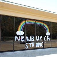 Window Writing reading "Newburgh Strong" along with a drawing of a rainbow. 