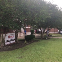 people in line at a brick building 