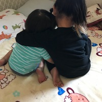 Two children sitting in bed together. 