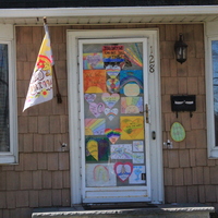 Residential house with multiple rainbows that cover the entire front screen door. 