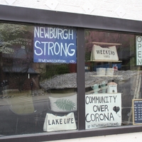 A sign in a business reading "Newburgh Strong #wewillsurvive".