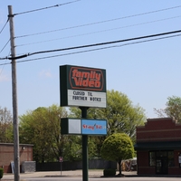 A sign outside of a family video store reading "Closed Til Further Notice"