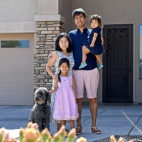 A family posing with a dog. 