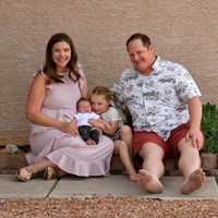 A family posing on a walkway. 