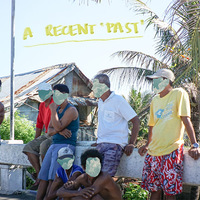 A photograph of seven men leaning on a barrier on the side of a road in front of a shack and palm tree. The faces of the men are blocked out. 