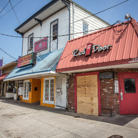 Businesses along Carrollton Avenue in New Orleans, LA, boarded shut.