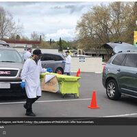 People in protective equipment providing curbside service.