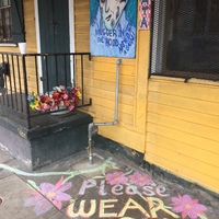 Sidewalk chalk in front of a building. 