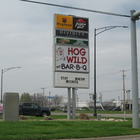 Image of business signs, the bottom one says stay healthy, Wichita. 