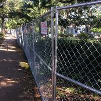 A chain fence in a park. 