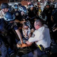 This is a picture of a group of police officers detaining a protester during the Black Lives Matter protests. 