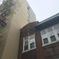 Two brick buildings, a red one on the right and a yellow one on the left. 