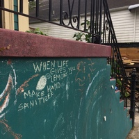 Chalk art on a stairway outside a house. 