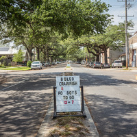 Sign that says "boiled crawfish & po boys to go 12-7."