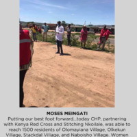 Men gathering on a dirt road.