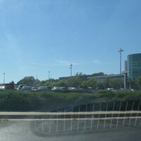 A photo of a building and a full parking lot.