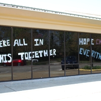 Window Writing reading "We Are All in This Together. Hope Changes Everything".